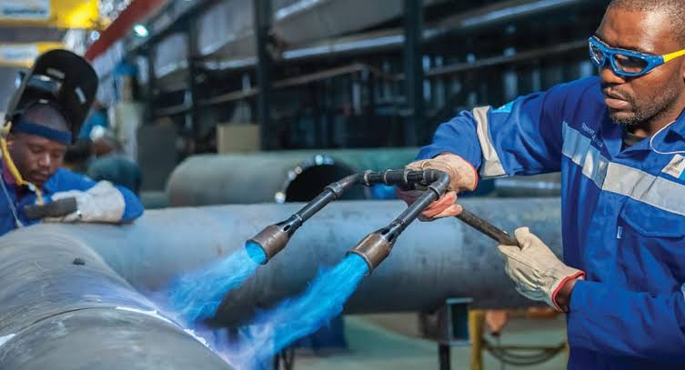New Mega Group artisans preheating a heavy-wall pipe spool in the fabrication workshop